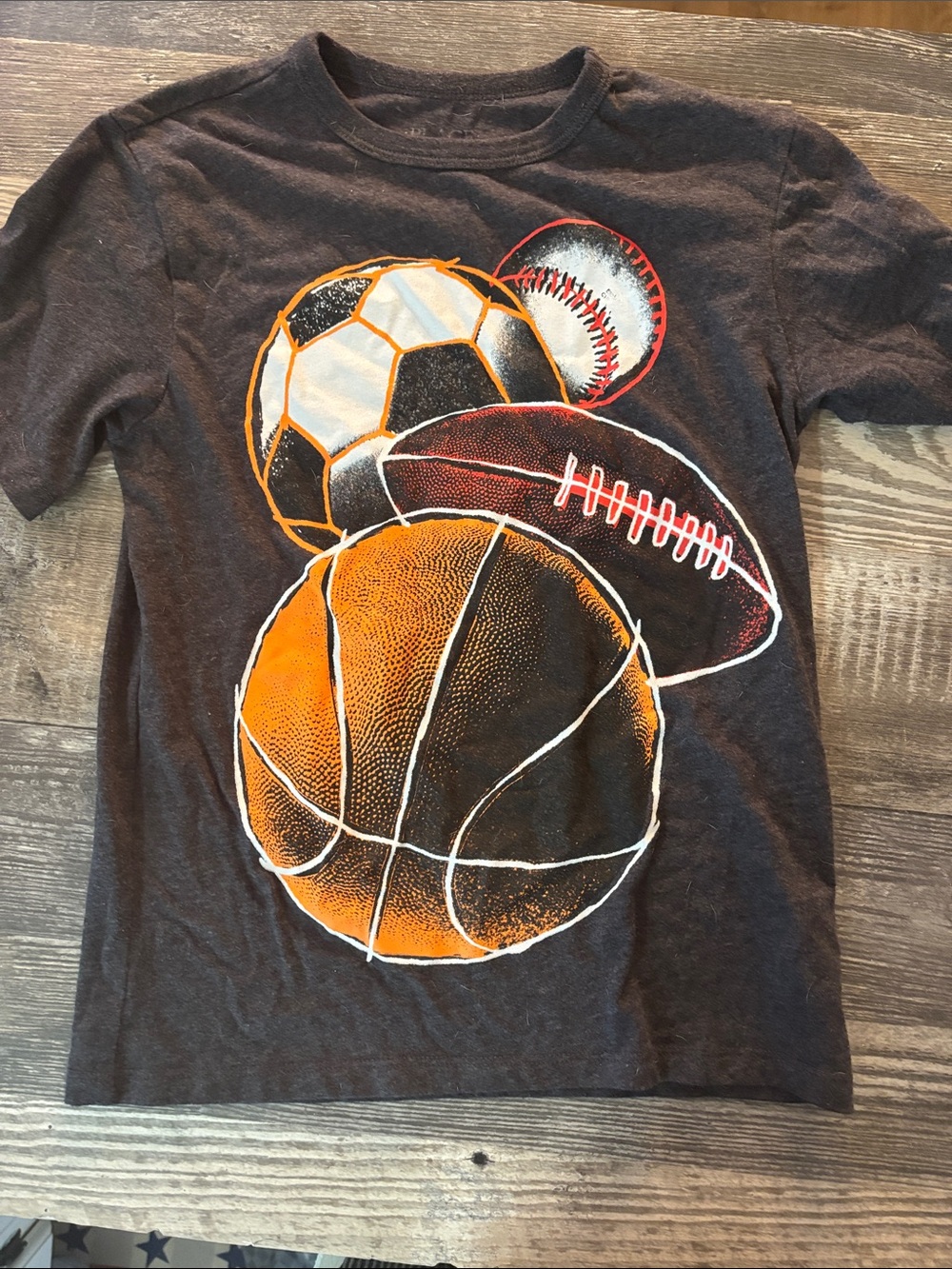 Place Black Short Sleeve Tee with Orange Sports Ball Graphics